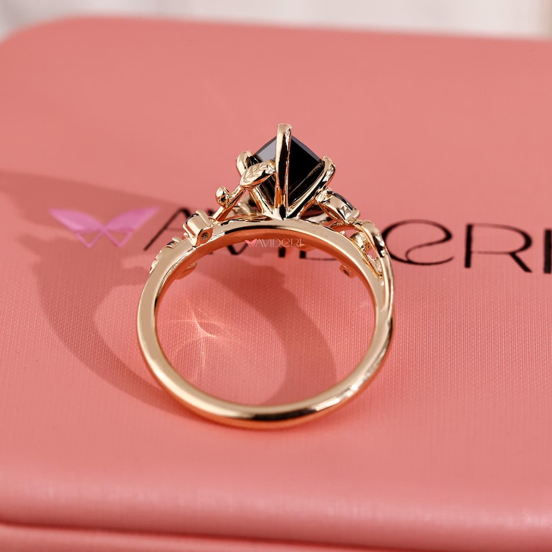 Black stone engagement ring in leaf style prong design.