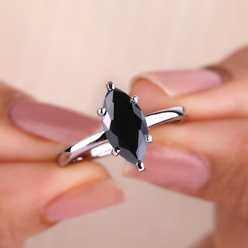 Marquise moissanite ring with a beautiful white gold engagement ring setting.