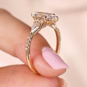 Kite and round side diamond ring for a unique look.