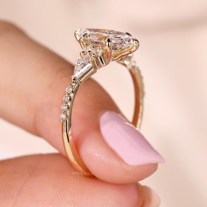 Kite and round side diamond ring for a unique look.