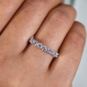 Front view of the seven stone lab-grown diamond anniversary band. Each diamond is meticulously set in white gold, forming a harmonious line of sparkling brilliance. The rings elegance is accentuated by its