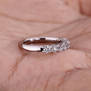 Side view of the eco-friendly diamond wedding band, displaying the white gold band's sleek and polished finish. The seamless craftsmanship ensures a comfortable fit, making it suitable for daily wear and special