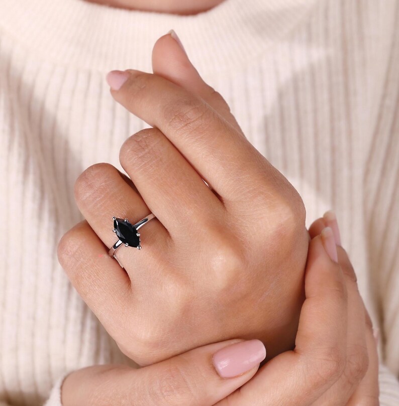 6 prong ring with a stunning marquise moissanite for added brilliance.