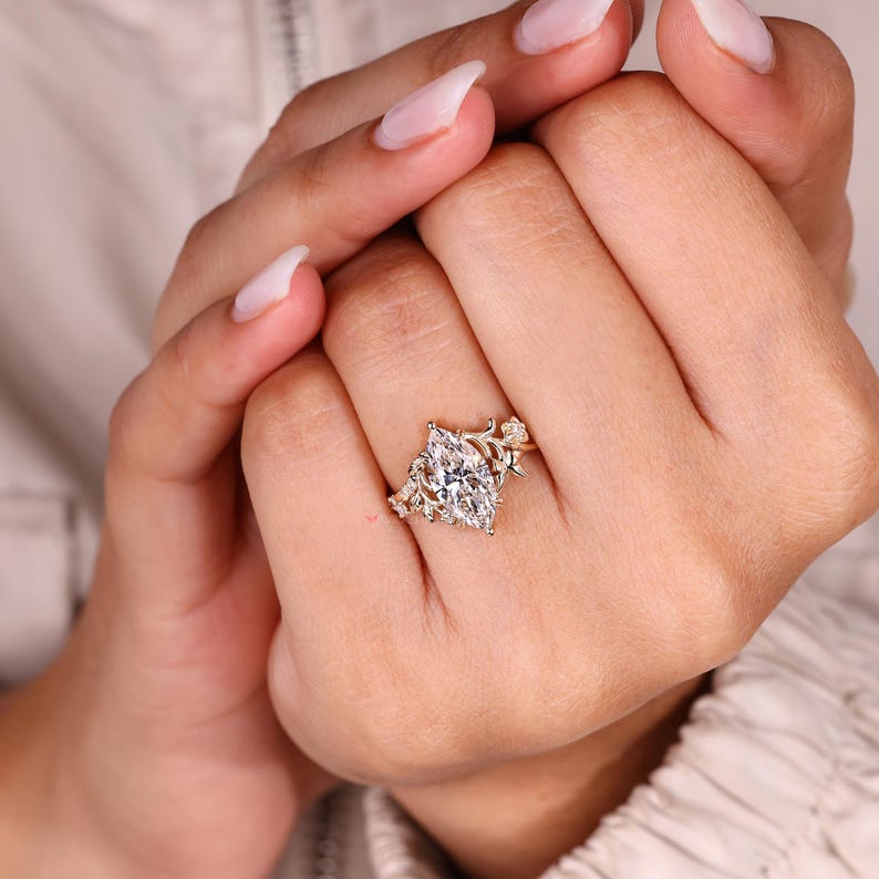 Marquise diamond ring with cathedral setting design.
