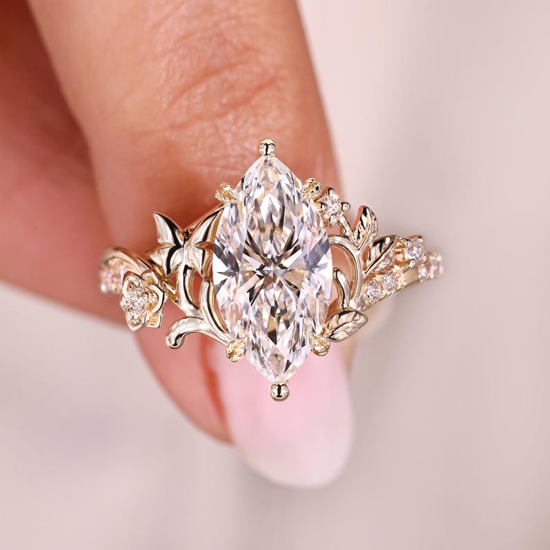Marquise diamond ring with round diamond accents.