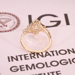 Lab grown marquise diamond ring with pave accents.