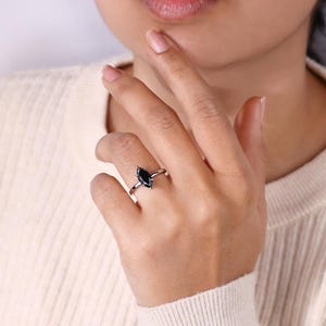 Engagement ring hidden halo with a radiant marquise moissanite centerpiece.
