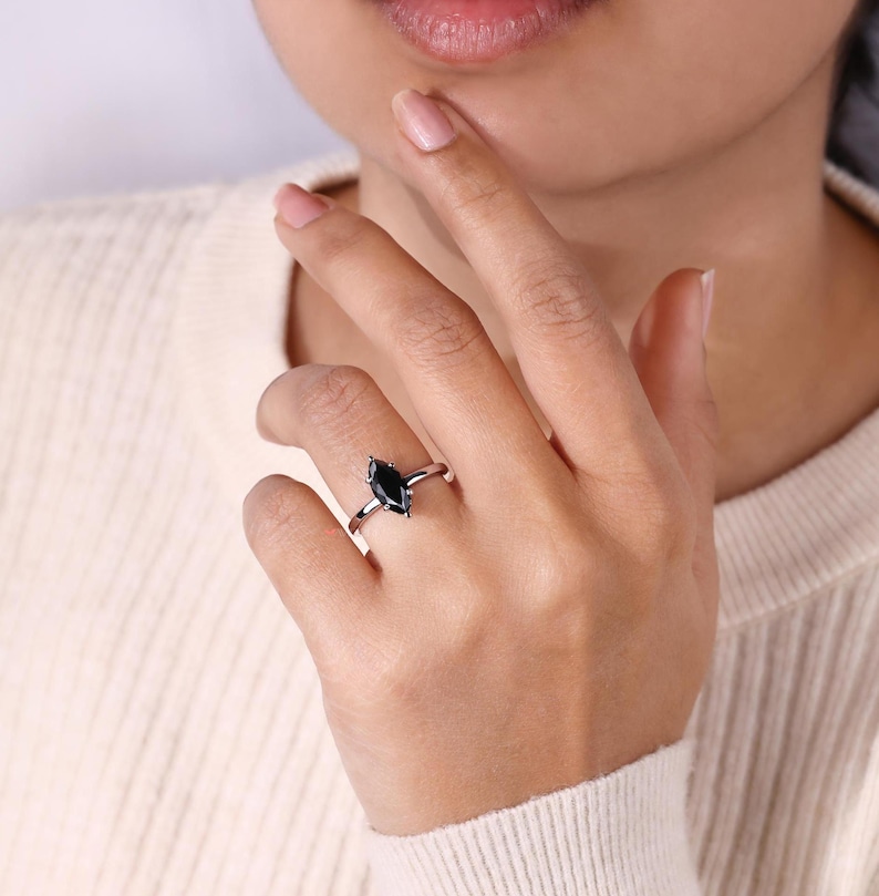 Engagement ring hidden halo with a radiant marquise moissanite centerpiece.