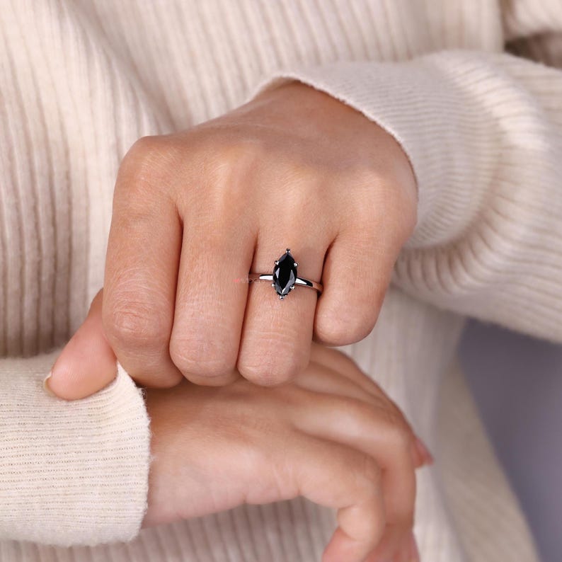 White gold engagement ring with a marquise moissanite for a classic design.
