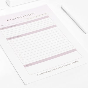 May include: A daily to-do list printable with a gradient background in pink and white. The printable has sections for date, most important, today's tasks, and notes. The text "A beautiful day begins with a beautiful mindset." is at the bottom of the page.