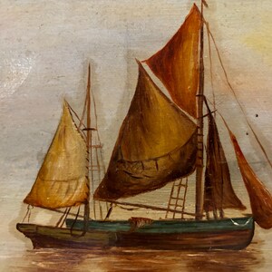 May include: A painting of two sailboats on a calm sea. The sailboat in the foreground has a brown sail and a green hull. The sailboat in the background has a white sail and a blue hull.