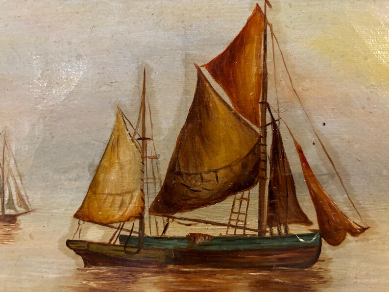 May include: A painting of two sailboats on a calm sea. The sailboat in the foreground has a brown sail and a green hull. The sailboat in the background has a white sail and a blue hull.