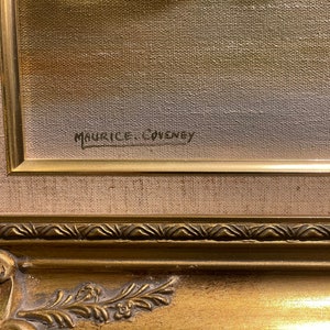 May include: Close-up of the signature "Maurice Couvney" on a framed painting. The signature is in black ink on a canvas with a beige background.