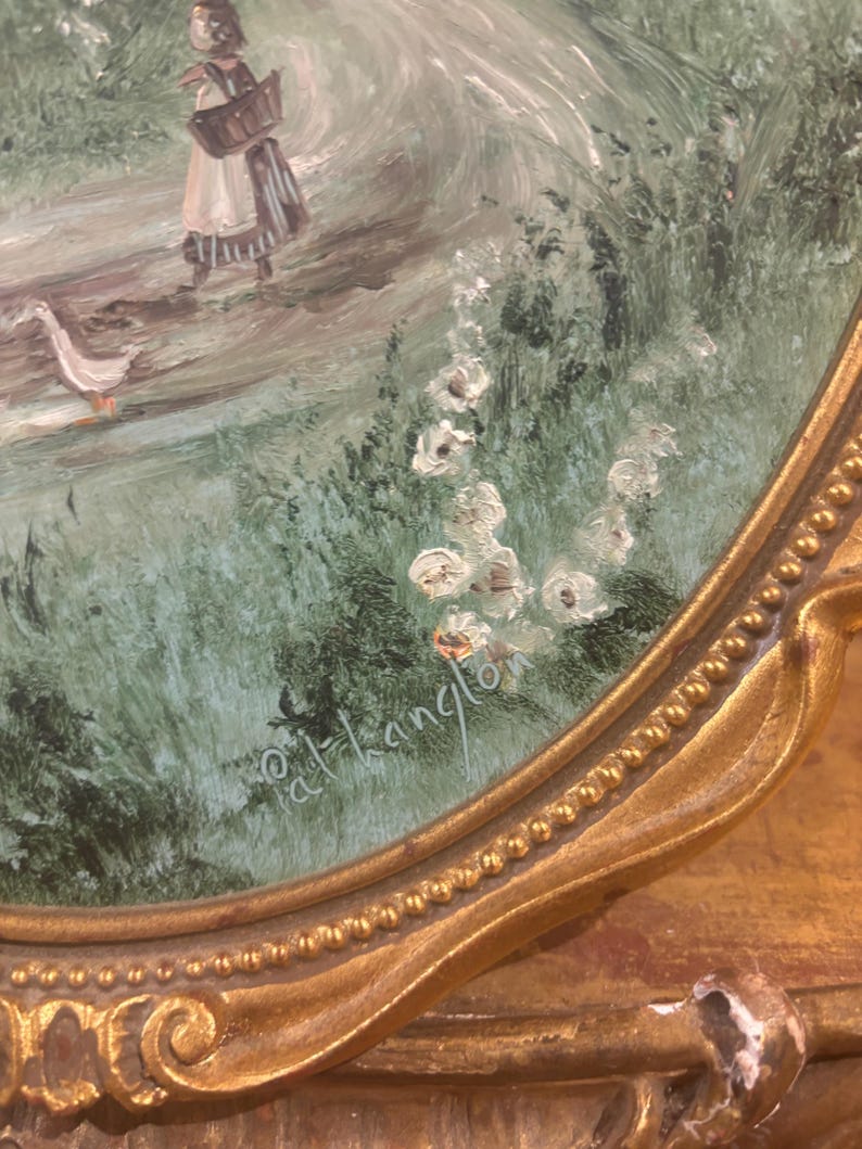 May include: A framed painting depicting a woman in a white dress walking with two geese along a path through a green field. The painting is signed "d.t.hanglon" in the bottom right corner.
