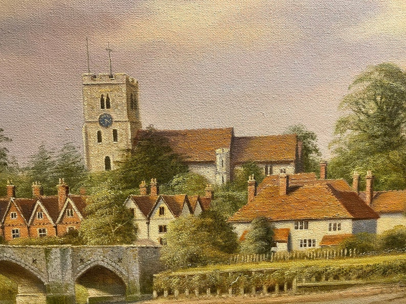 May include: A painting depicting a quaint English village with a church tower, houses, and a stone bridge. The scene is bathed in soft, warm light, creating a peaceful and idyllic atmosphere.