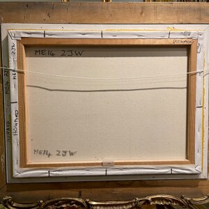 May include: The back of a framed painting with the text "ME14 2JW" written on it. The frame is made of wood and has a gold finish.