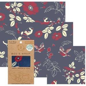 May include: Reusable food wraps with a floral and bird pattern in red, cream, and navy blue. The wraps are assorted sizes and are made by Bee's Wrap. The packaging indicates the wraps are for sustainable food storage.