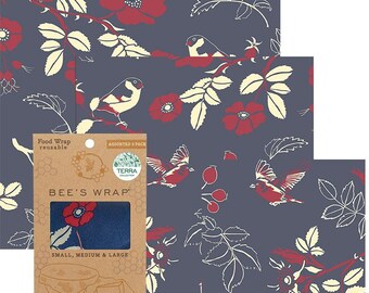 May include: Reusable food wraps with a floral and bird pattern in red, cream, and navy blue. The wraps are assorted sizes and are made by Bee's Wrap. The packaging indicates the wraps are for sustainable food storage.