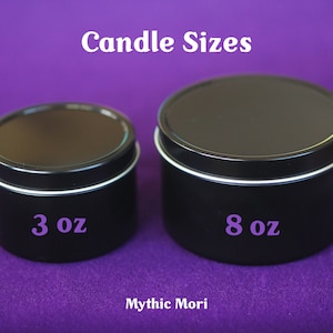 May include: Two black metal candle tins, one labeled "3 oz" and the other labeled "8 oz". The tins are on a purple surface. Candle Sizes.