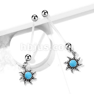 May include: Two industrial barbells with clear flexible shafts and silver-colored ball ends. Each barbell has a dangling charm featuring a sunburst design with a turquoise center. The image is set against a white background.