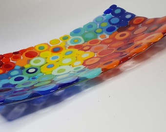 May include: A rectangular glass serving dish with a colorful design of overlapping circles in shades of red, orange, yellow, green, blue, and purple.