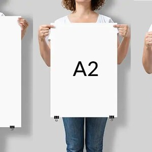 May include: Three people holding up white paper sheets with the letters A1, A2, and A3 printed on them.