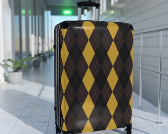 May include: A rolling suitcase with a brown, black, and yellow argyle pattern. The suitcase has a retractable handle and four wheels. The luggage is in a hallway with white walls and a tiled floor.