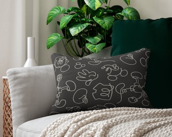 May include: A gray throw pillow with a white outline of Mickey Mouse characters and symbols on a dark gray background.
