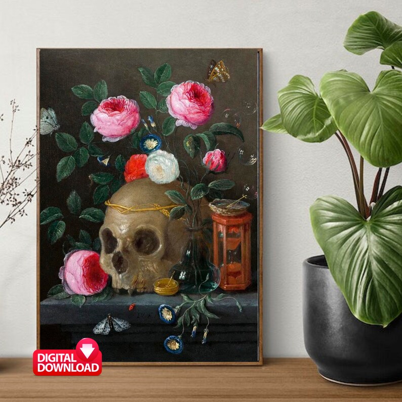 May include: A framed digital print of a still life painting featuring a human skull adorned with a gold crown, surrounded by pink and white roses, butterflies, and other symbolic objects. The artwork has a dark, moody aesthetic.
