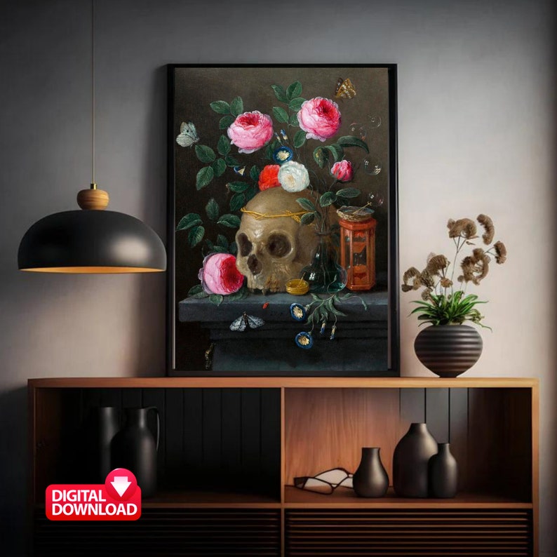 May include: A framed digital download of a still life painting featuring a skull adorned with a gold crown, surrounded by pink and white roses, butterflies, and other decorative elements. The artwork is displayed on a dark surface.