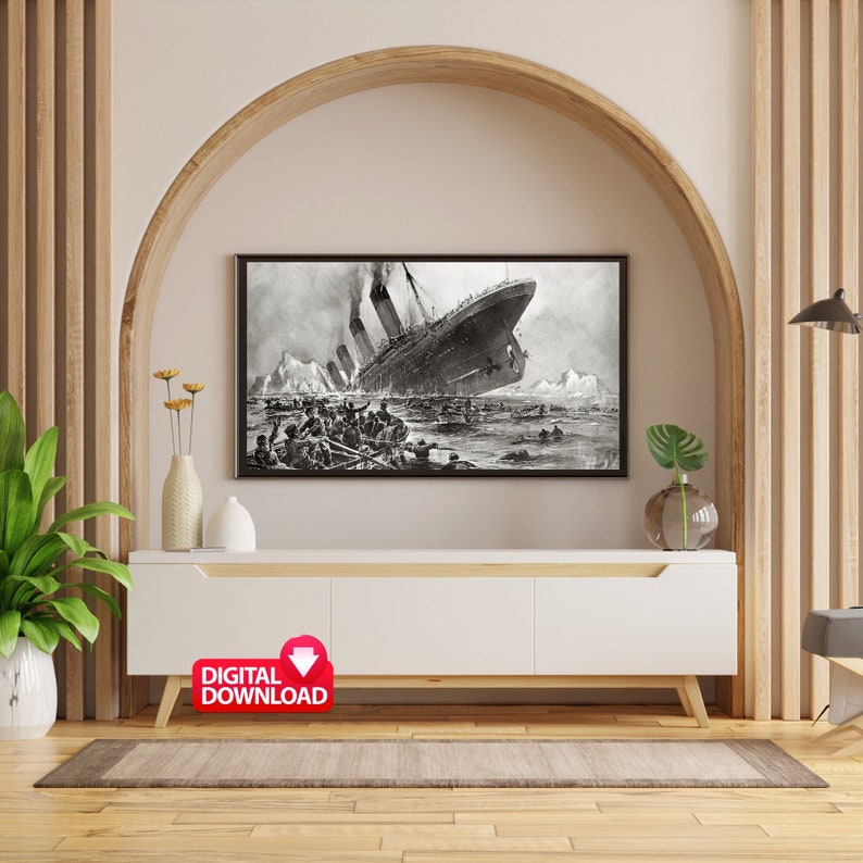 May include: A black and white photograph of the RMS Titanic sinking. The ship is partially submerged in the water, with people in lifeboats and on deck. The image is framed and displayed on a white shelf above a white cabinet.