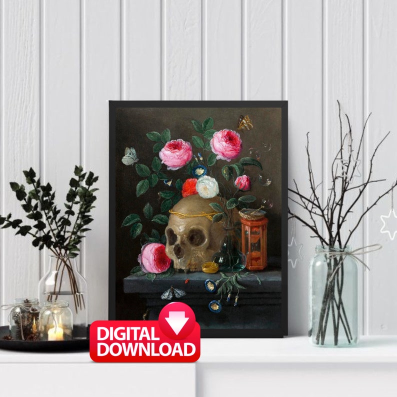 May include: A framed digital download print featuring a still life with a skull, pink roses, butterflies, and a small decorative jar. The skull is adorned with a gold band. The print has a dark background and is displayed on a white shelf.