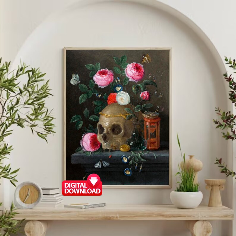 May include: A framed digital download of a still life painting featuring a skull adorned with a gold crown, surrounded by pink and white roses, butterflies, and a small red and gold container. The background is dark.