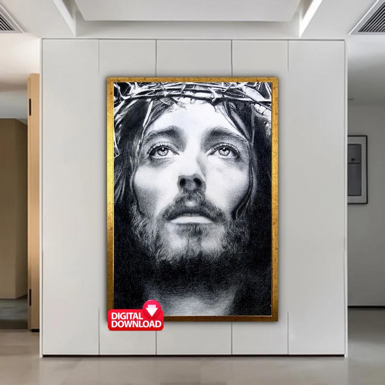 May include: Black and white drawing of Jesus Christ wearing a crown of thorns. The image is a close-up of his face and features a realistic style.