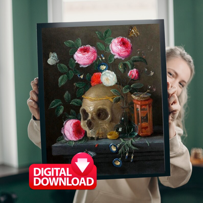 May include: A framed digital download print featuring a still life with a skull, roses, and butterflies. The skull is adorned with a gold crown, and the flowers are pink, red, and white. The print has a dark background and a red "DIGITAL DOWNLOAD" sticker.