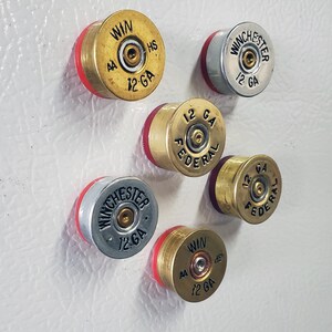 Six Fridge Magnets made with 12 Gauge Shotgun Brass on fridge side view