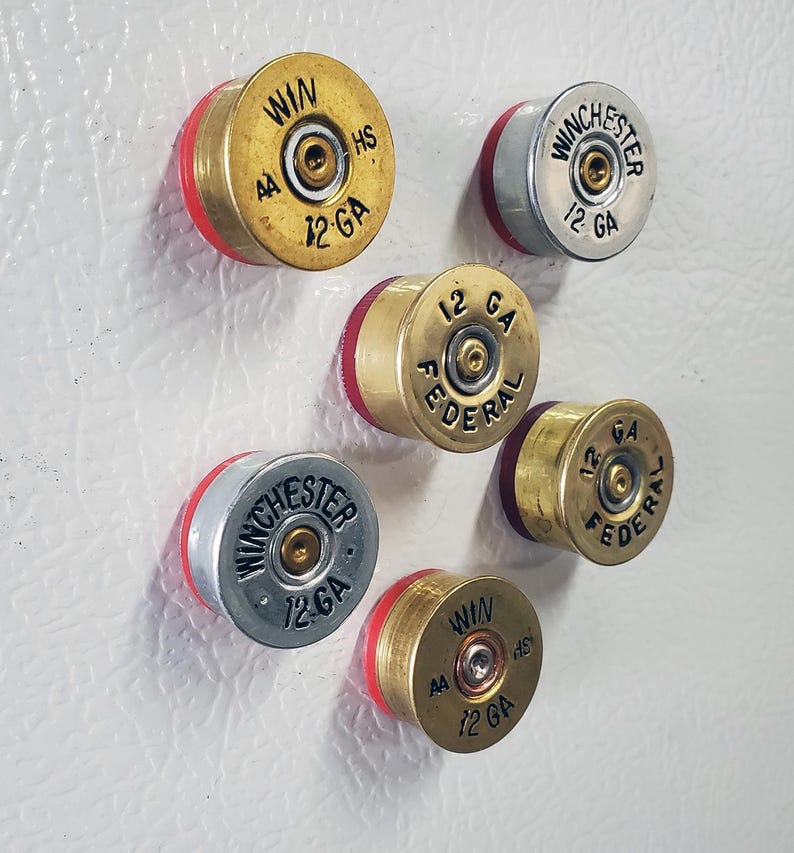 Six Fridge Magnets made with 12 Gauge Shotgun Brass on fridge side view