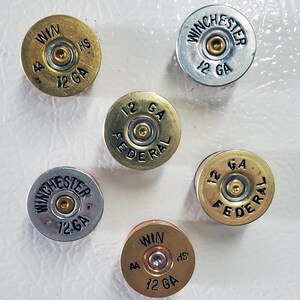Six Fridge Magnets made with 12 Gauge Shotgun Brass on fridge