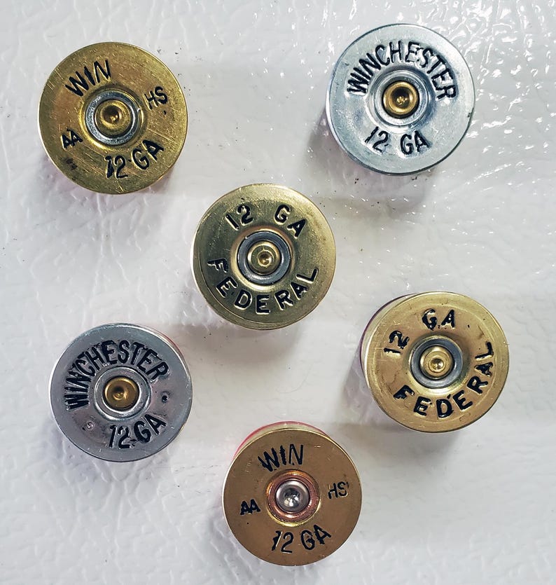 Six Fridge Magnets made with 12 Gauge Shotgun Brass on fridge