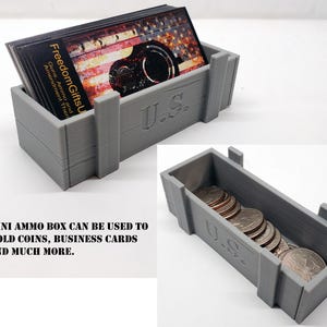 May include: A gray, rectangular mini ammo box with the text "U.S." on the front. The box is filled with business cards and coins. The business cards have an American flag design and the text "Freedom Gifts U".