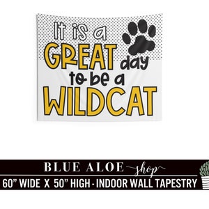 May include: A white tapestry with black polka dots and a black paw print. The text "It is a GREAT day to be a WILDCAT" is in yellow and black letters. The tapestry is 60 inches wide and 50 inches high.