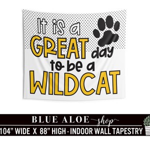 May include: A white tapestry with black polka dots and a black paw print. The text "It is a GREAT day to be a WILDCAT" is in yellow letters. The tapestry is 104 inches wide and 88 inches high.