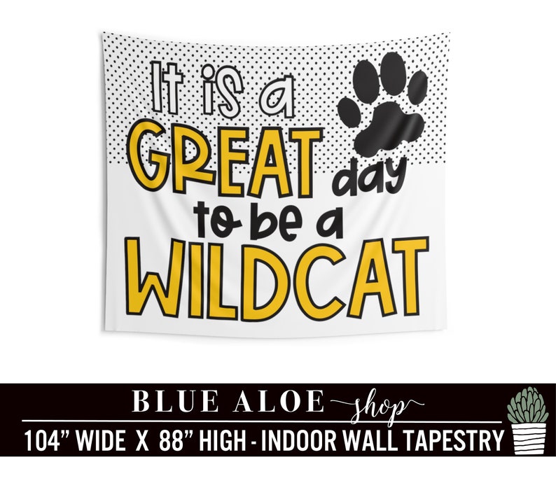 May include: A white tapestry with black polka dots and a black paw print. The text "It is a GREAT day to be a WILDCAT" is in yellow letters. The tapestry is 104 inches wide and 88 inches high.