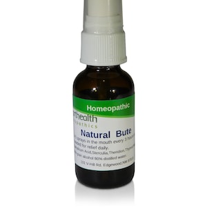 May include: A brown glass bottle with a white spray nozzle. The bottle is labeled "Natural Bute Homeopathic" and contains a liquid. The label also includes the text "101 V-Hill Rd. Edgewood, NM 87015".