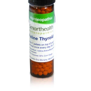 May include: A small brown glass bottle with a white label that reads "Homeopathic Smarthealth Naturopathics Feline Thyroid". The label also includes instructions for use and ingredients. The bottle is filled with small orange pellets.