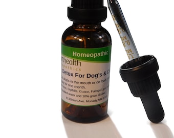 May include: A brown glass bottle with a dropper labeled "Detox For Dog's & Cats" with the text "Homeopathic" on the label. The bottle is labeled "Earth Health Homeopathics" and has the address "811 Union Ave. Moriarty, NM 87035".