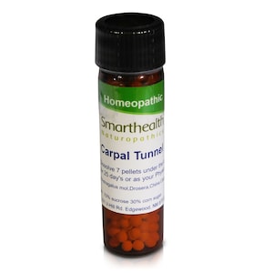 May include: A brown glass bottle with a black lid containing small orange pellets. The label reads "Homeopathic Smarthealth Naturopathics Carpal Tunnel Dissolve 7 pellets under the tongue 3 times daily for 25 days or as your Physician directs. Ingredients: Arnica Montana 3x,  Astragalus mol. Drosera, China Officinalis 3x,  Rhus Tox 6x. 100% sucrose 30% corn sugar. Smarthealth Naturopathics 144 Hill Rd. Edgewood, NM 87015"