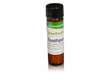 May include: A small brown glass bottle with a black lid containing red pellets. The bottle label reads "Homeopathic Smarthealth Naturopathic Toothpa" and includes instructions for use.