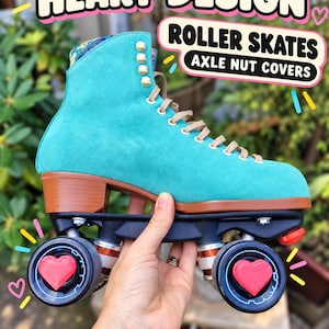 May include: A turquoise suede roller skate featuring a brown heel and sole, beige laces, and black wheels. Each wheel is equipped with a bright pink heart-shaped axle nut cover. The text HEART DESIGN ROLLER SKATES AXLE NUT COVERS is visible.