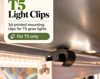May include: A black 3D-printed mounting clip attached to a white T5 grow light. The text on the image reads: Barrina T5 Light Clips, 3d-printed mounting clips for T5 grow lights, For T5 only. The clip secures the light fixture to a surface.